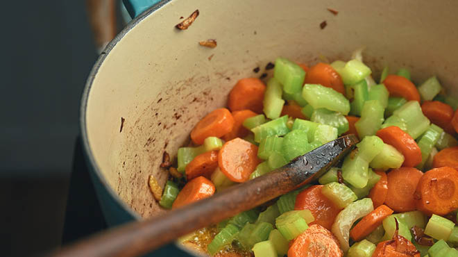 Celery and carrots cooking in pan