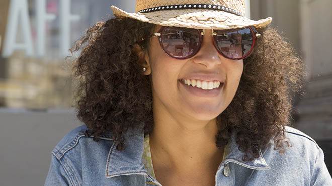 Person wearing hat and sunglasses